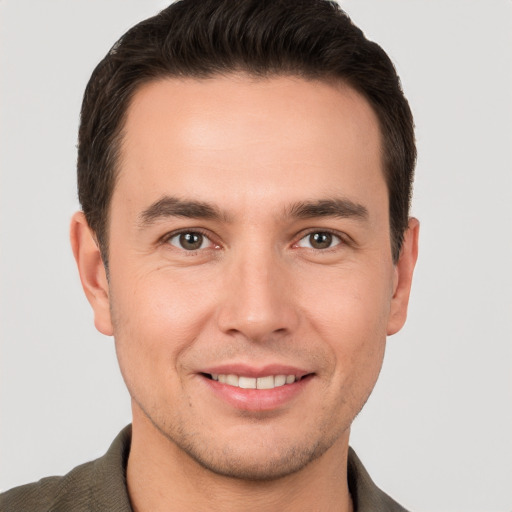 Joyful white young-adult male with short  brown hair and brown eyes