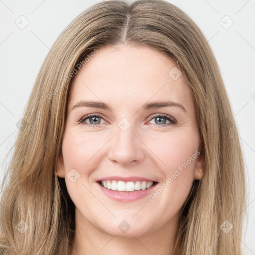 Joyful white young-adult female with long  brown hair and green eyes