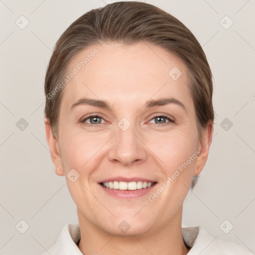 Joyful white adult female with short  brown hair and grey eyes