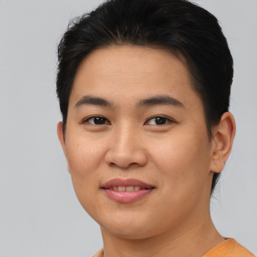 Joyful asian young-adult female with short  brown hair and brown eyes