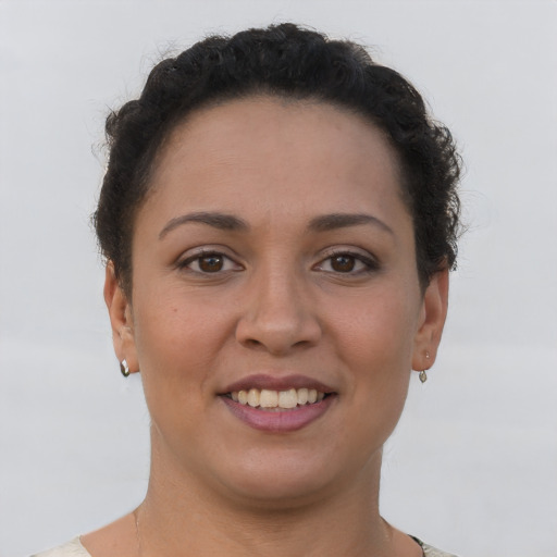 Joyful latino young-adult female with short  brown hair and brown eyes
