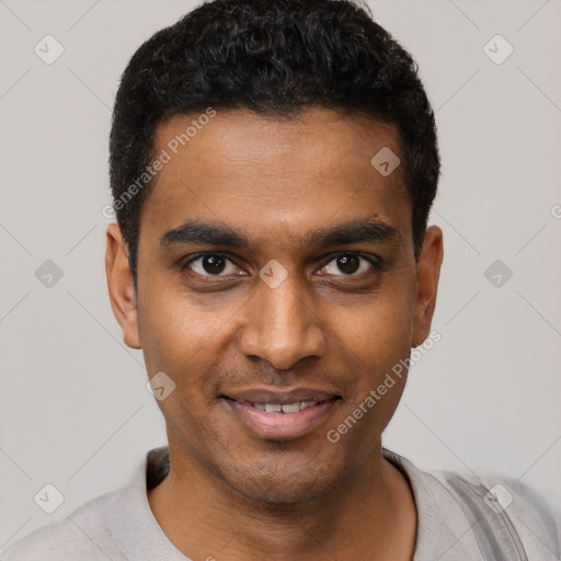 Joyful black young-adult male with short  black hair and brown eyes