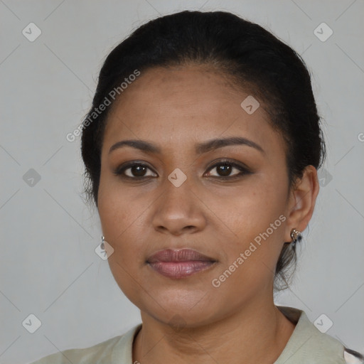 Joyful black young-adult female with short  black hair and brown eyes