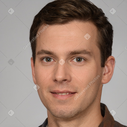 Joyful white young-adult male with short  brown hair and grey eyes