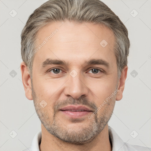 Joyful white adult male with short  brown hair and brown eyes