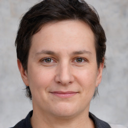 Joyful white adult female with medium  brown hair and grey eyes