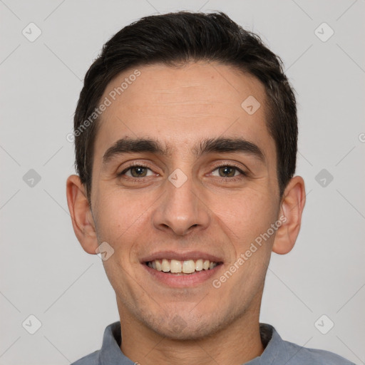 Joyful white young-adult male with short  black hair and brown eyes