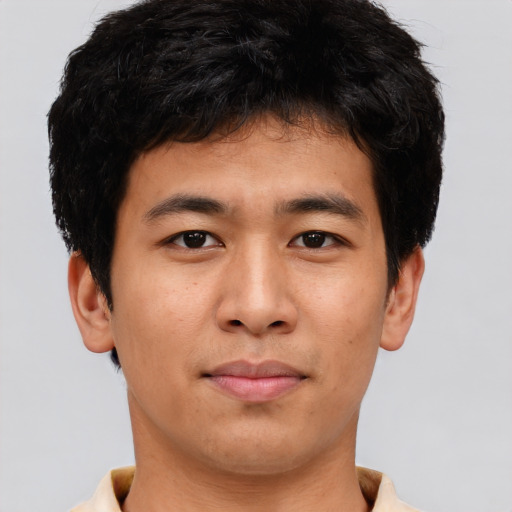 Joyful asian young-adult male with short  brown hair and brown eyes