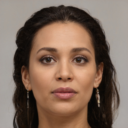 Joyful latino young-adult female with long  brown hair and brown eyes