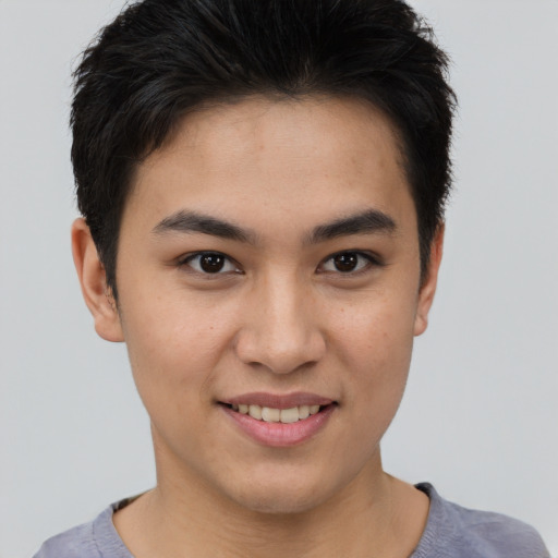 Joyful asian young-adult male with short  brown hair and brown eyes
