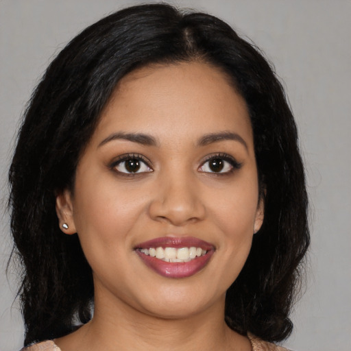 Joyful latino young-adult female with medium  black hair and brown eyes