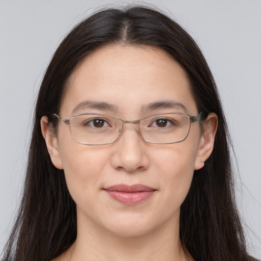 Joyful white adult female with long  brown hair and brown eyes