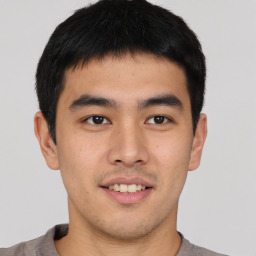 Joyful asian young-adult male with short  brown hair and brown eyes