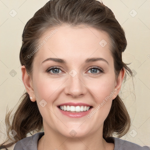 Joyful white young-adult female with medium  brown hair and grey eyes