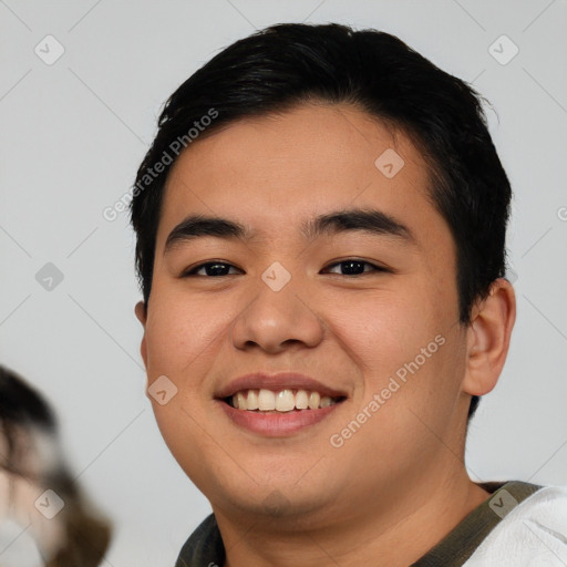 Joyful asian young-adult male with short  black hair and brown eyes