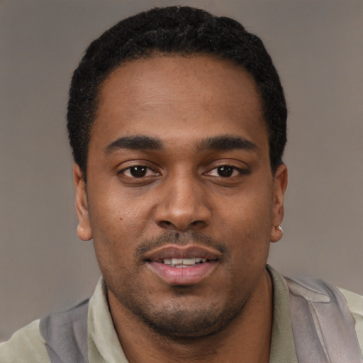 Joyful black young-adult male with short  black hair and brown eyes