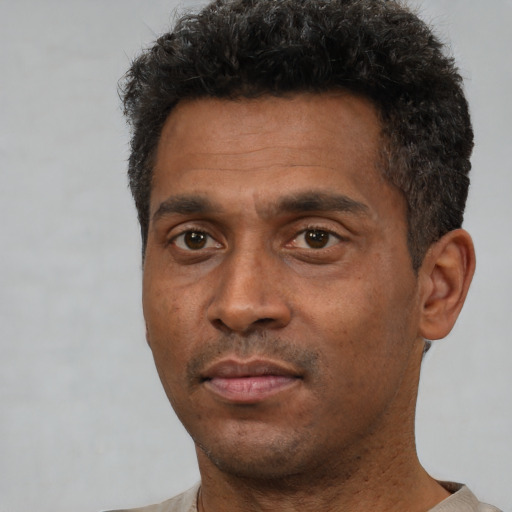 Neutral black adult male with short  black hair and brown eyes