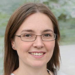 Joyful white young-adult female with medium  brown hair and blue eyes