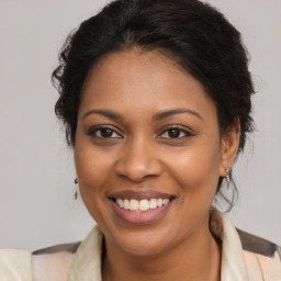 Joyful black young-adult female with medium  brown hair and brown eyes