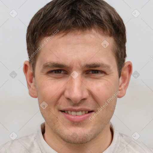 Joyful white young-adult male with short  brown hair and grey eyes