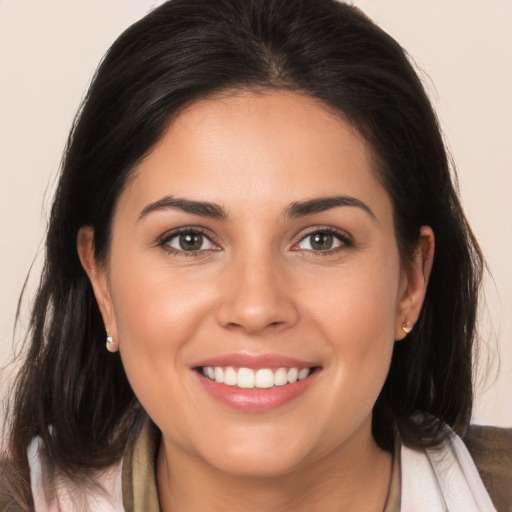 Joyful white young-adult female with medium  brown hair and brown eyes