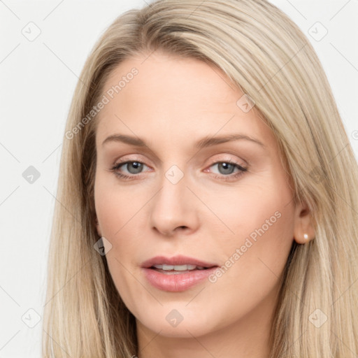 Joyful white young-adult female with long  brown hair and blue eyes