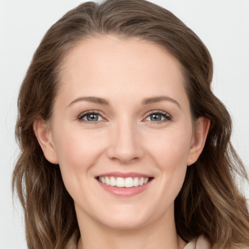 Joyful white young-adult female with long  brown hair and grey eyes