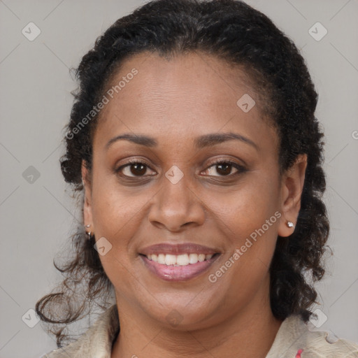 Joyful black adult female with long  brown hair and brown eyes