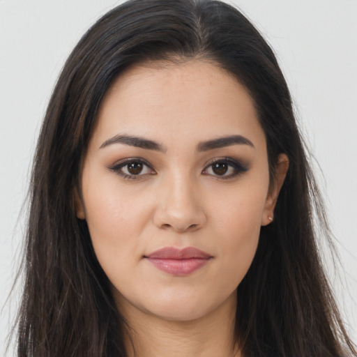 Joyful asian young-adult female with long  brown hair and brown eyes
