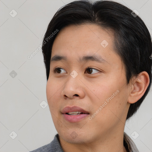 Joyful asian young-adult male with short  black hair and brown eyes