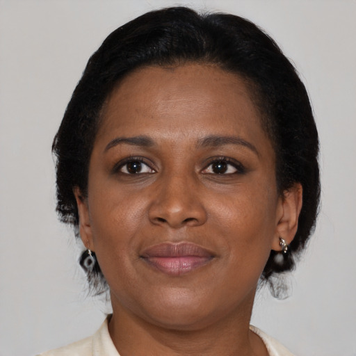 Joyful black adult female with medium  brown hair and brown eyes