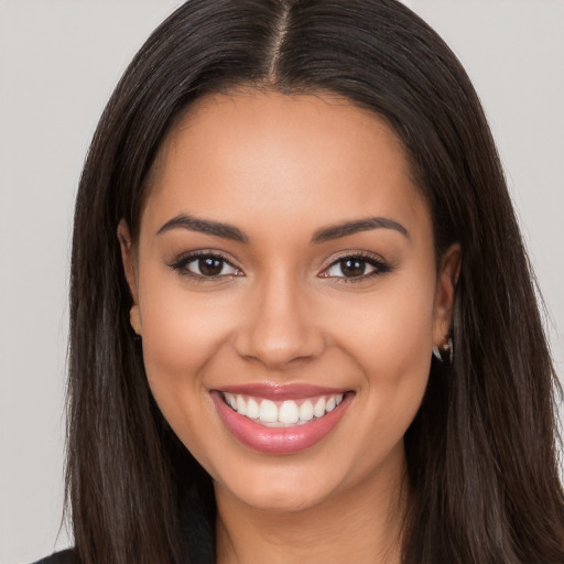 Joyful white young-adult female with long  brown hair and brown eyes