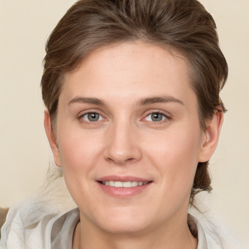 Joyful white young-adult female with medium  brown hair and grey eyes