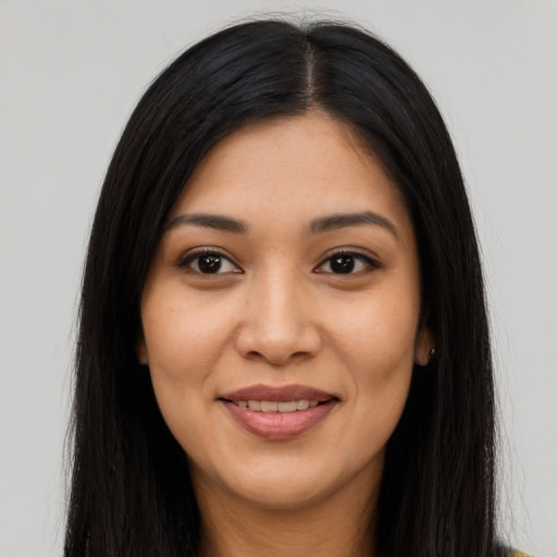 Joyful latino young-adult female with long  black hair and brown eyes