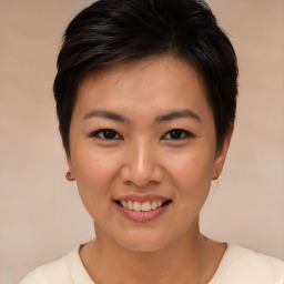 Joyful asian young-adult female with short  brown hair and brown eyes