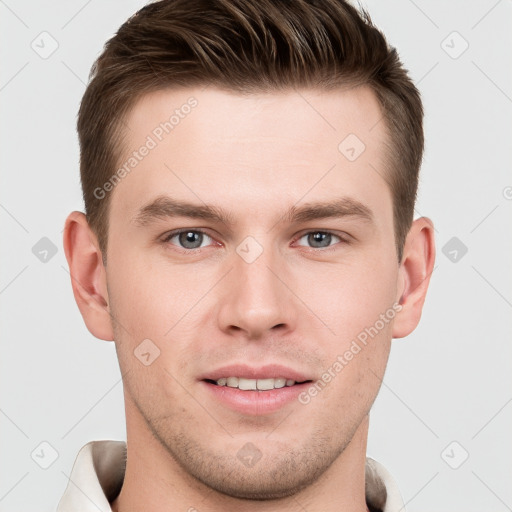 Joyful white young-adult male with short  brown hair and grey eyes