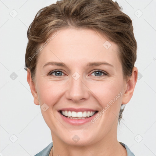 Joyful white young-adult female with short  brown hair and grey eyes