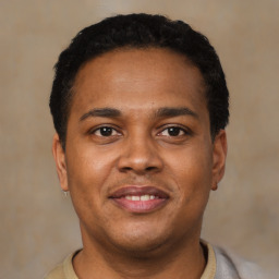 Joyful latino young-adult male with short  brown hair and brown eyes