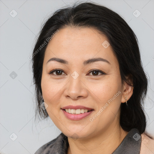 Joyful asian adult female with medium  brown hair and brown eyes