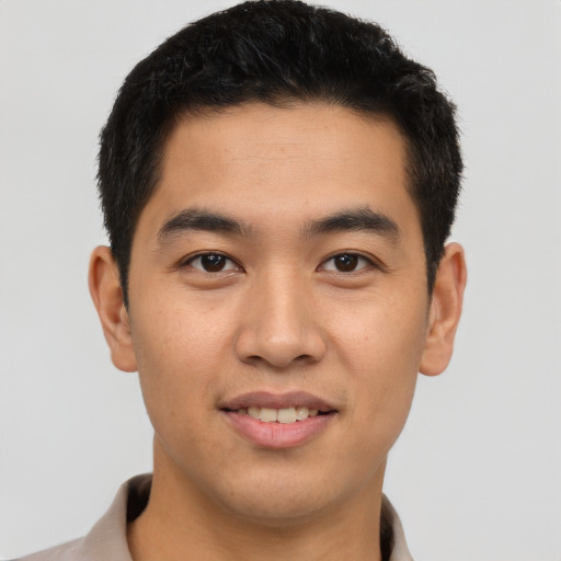 Joyful latino young-adult male with short  brown hair and brown eyes
