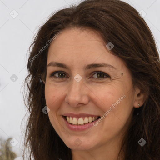 Joyful white adult female with long  brown hair and brown eyes