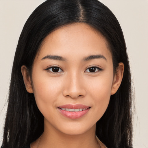 Joyful asian young-adult female with long  brown hair and brown eyes