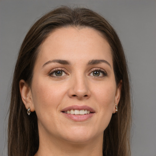 Joyful white young-adult female with long  brown hair and grey eyes