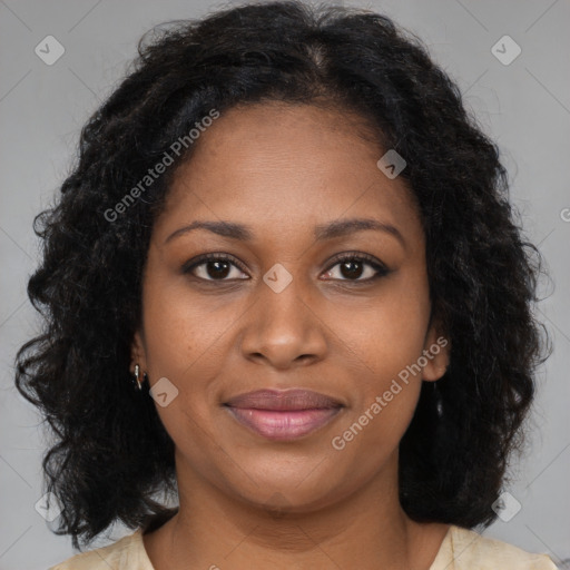 Joyful black young-adult female with long  brown hair and brown eyes