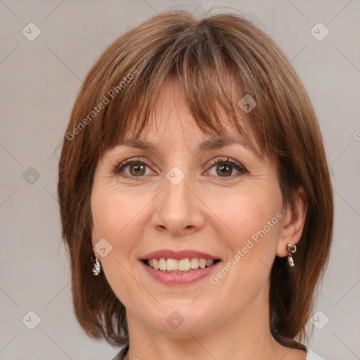 Joyful white adult female with medium  brown hair and blue eyes