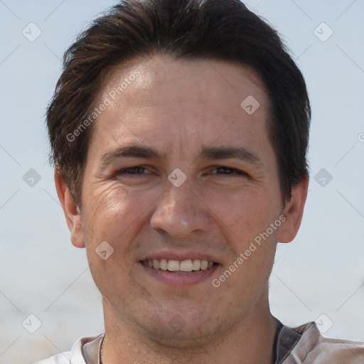 Joyful white adult male with short  brown hair and brown eyes