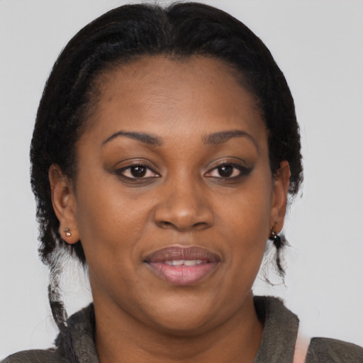 Joyful black adult female with medium  brown hair and brown eyes