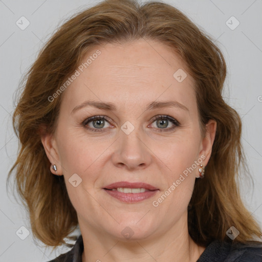 Joyful white adult female with medium  brown hair and blue eyes