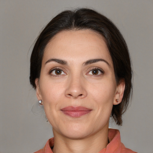 Joyful white adult female with medium  brown hair and brown eyes