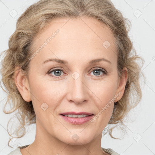 Joyful white adult female with medium  brown hair and blue eyes